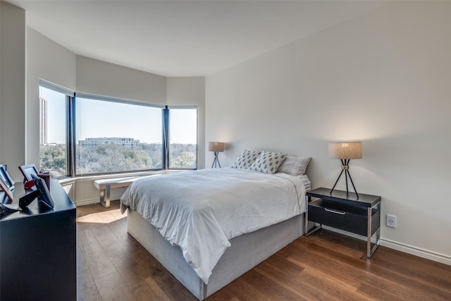 bedroom featuring dark wood-type flooring and baseboards