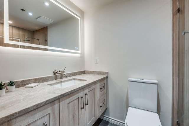 bathroom featuring recessed lighting, toilet, walk in shower, and vanity