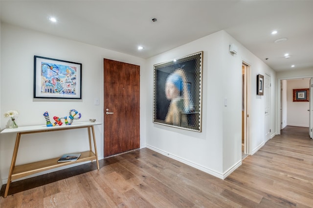 entrance foyer featuring recessed lighting, wood finished floors, and baseboards