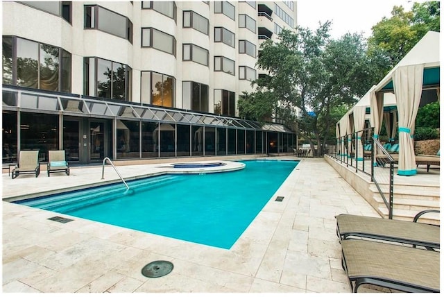 view of swimming pool with a patio area and a community hot tub