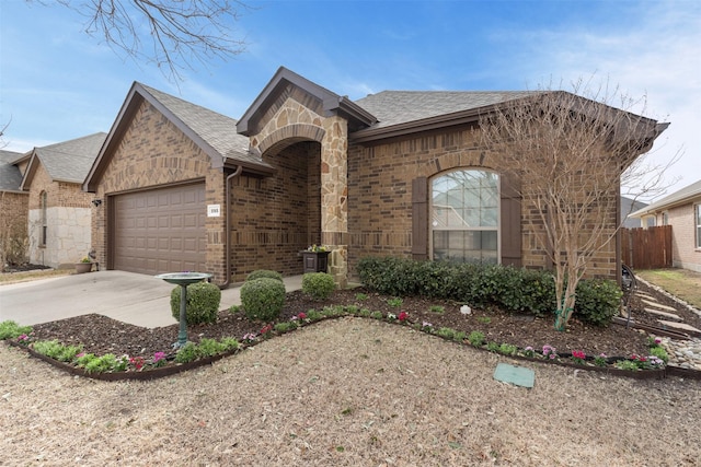 view of front of home featuring concrete driveway, brick siding, an attached garage, and a shingled roof