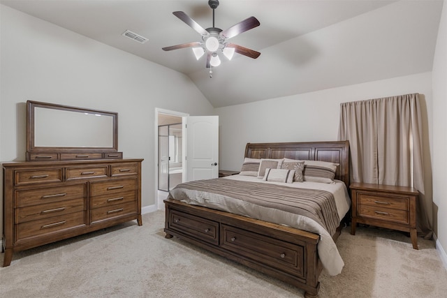 bedroom with visible vents, a ceiling fan, light colored carpet, lofted ceiling, and ensuite bath