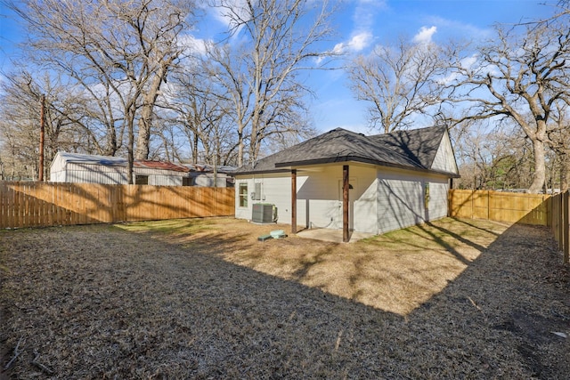 exterior space with fence and central AC