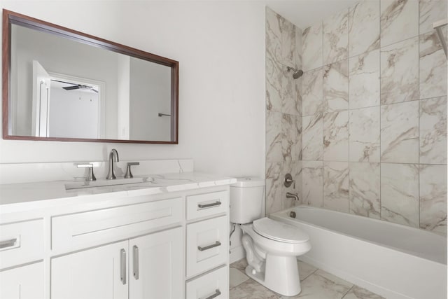 bathroom with toilet, vanity, a ceiling fan, marble finish floor, and tub / shower combination