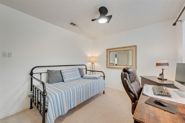 bedroom featuring a textured ceiling, carpet flooring, visible vents, and baseboards