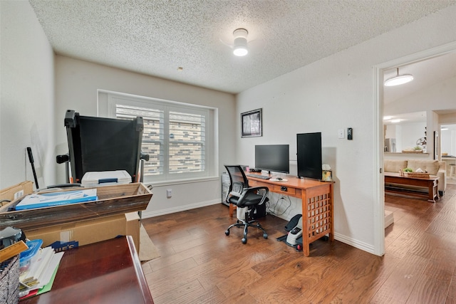 office featuring a textured ceiling, wood finished floors, and baseboards