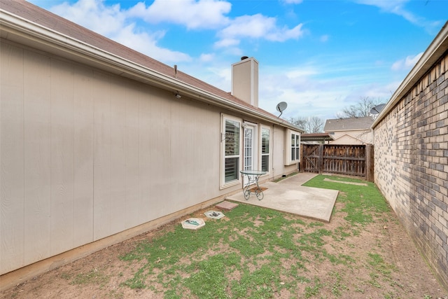 view of yard featuring fence and a patio