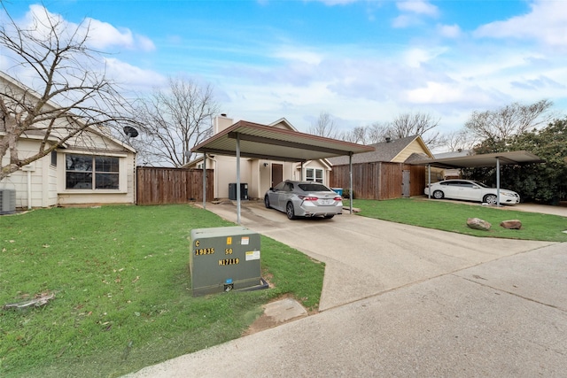 view of front of house with fence, concrete driveway, a carport, a chimney, and a front yard