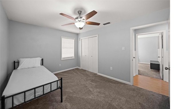 bedroom with carpet floors, a closet, visible vents, and baseboards