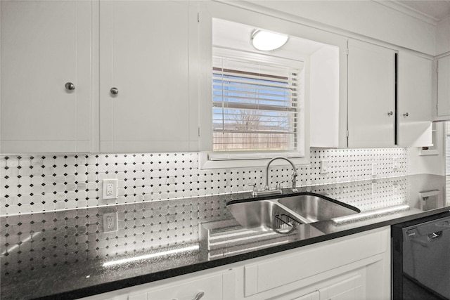 kitchen featuring black dishwasher, backsplash, a sink, and white cabinets