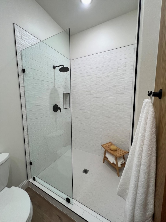 bathroom featuring toilet and walk in shower