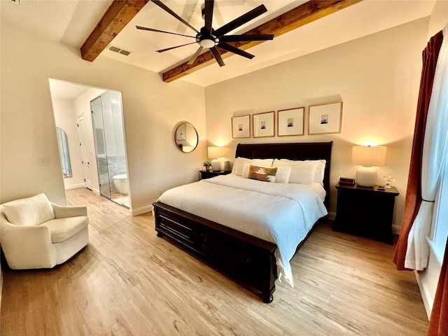 bedroom with ensuite bathroom, visible vents, baseboards, light wood-type flooring, and beam ceiling