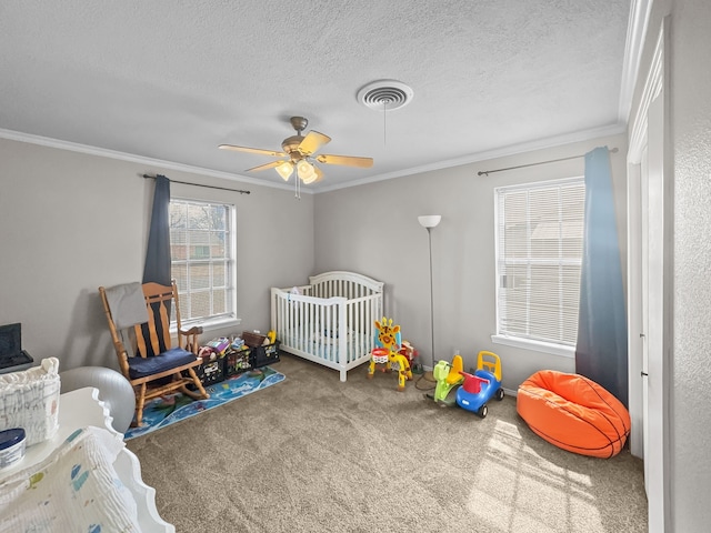 bedroom with a ceiling fan, visible vents, carpet floors, a textured ceiling, and crown molding