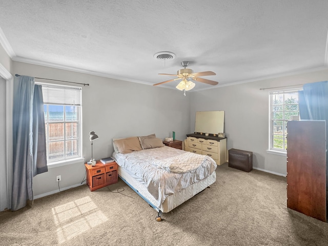 bedroom featuring visible vents, carpet, baseboards, ornamental molding, and a textured ceiling