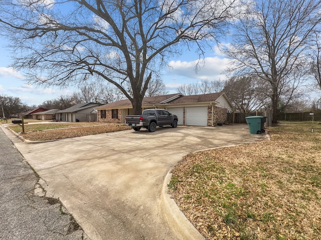 view of front facade featuring an attached garage, brick siding, and driveway