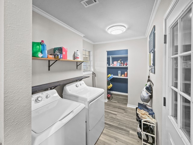 laundry area with visible vents, separate washer and dryer, crown molding, and laundry area