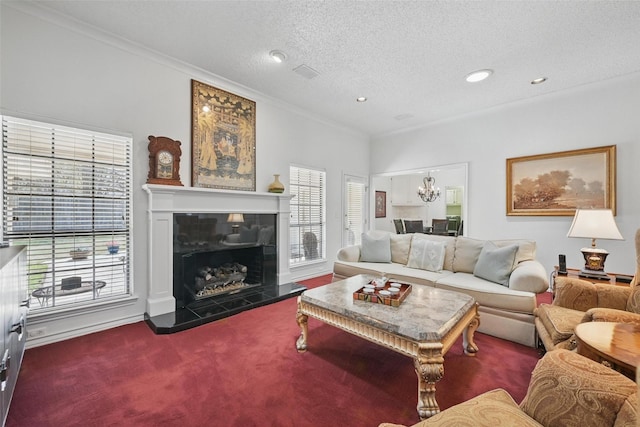 3620 Red Oak Dr, Corinth, TX 76208 - living area featuring ornamental molding, plenty of natural light, a chandelier, carpet floors, and a tiled fireplace