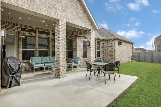 view of patio with area for grilling, outdoor lounge area, and fence