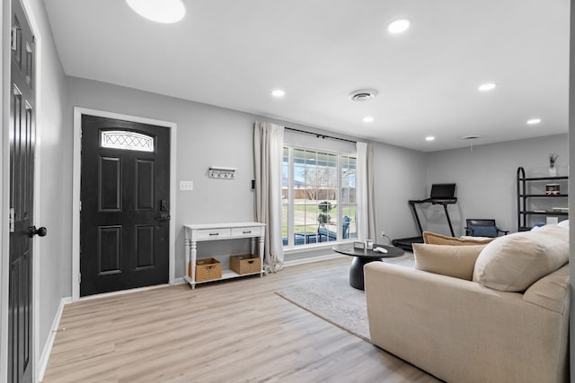 living area featuring recessed lighting, baseboards, visible vents, and light wood finished floors