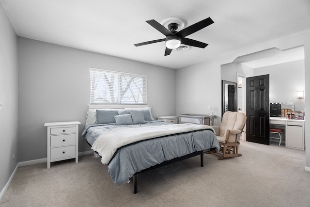 bedroom with ceiling fan, baseboards, and light colored carpet