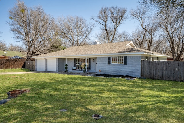 ranch-style house featuring a garage, a front yard, brick siding, and fence