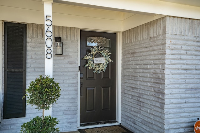 entrance to property with brick siding