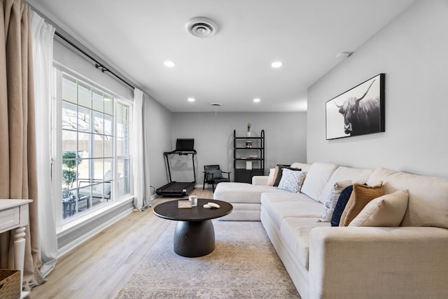 living area with recessed lighting, visible vents, and light wood-style flooring