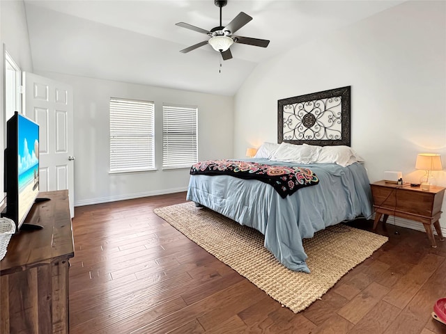 bedroom with lofted ceiling, multiple windows, baseboards, and wood finished floors