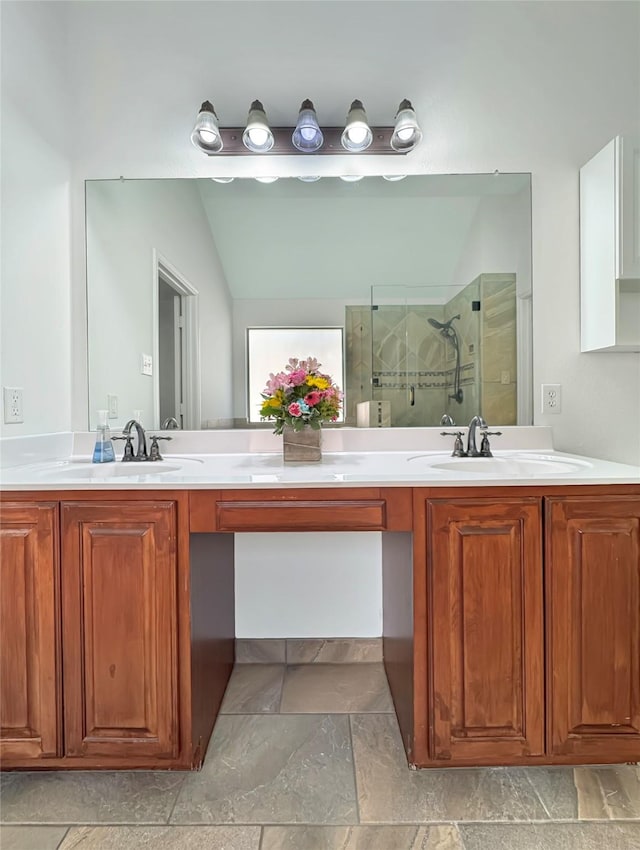 bathroom featuring a sink, double vanity, tiled shower, and lofted ceiling