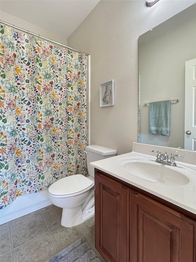 full bath with a shower with shower curtain, vanity, toilet, and tile patterned floors