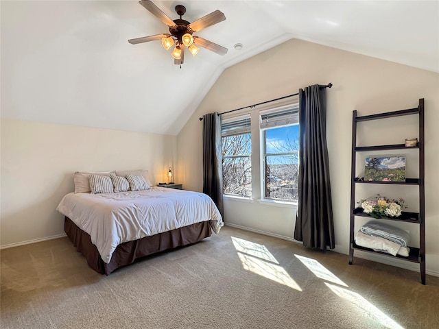 carpeted bedroom featuring lofted ceiling, ceiling fan, and baseboards