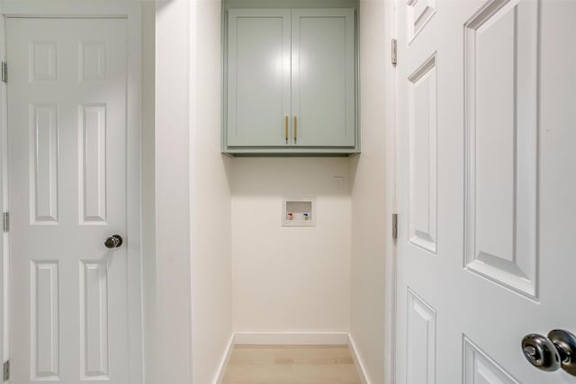 laundry room featuring light wood-style flooring, washer hookup, cabinet space, and baseboards