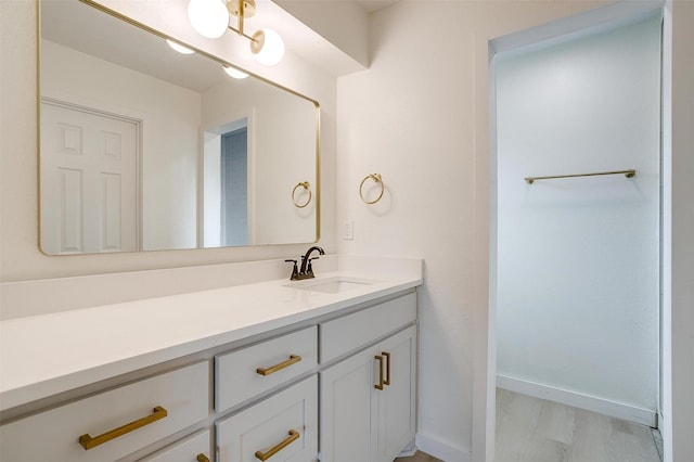 bathroom featuring vanity and baseboards