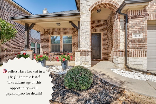 entrance to property featuring a porch and brick siding