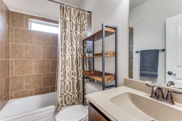 bathroom with shower / tub combo, toilet, vanity, and a textured wall