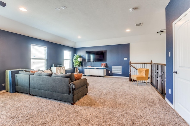 carpeted living area featuring visible vents, recessed lighting, and baseboards