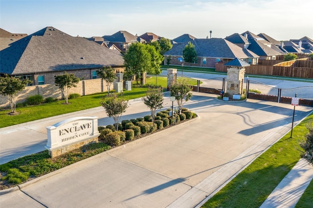 view of property's community featuring a gate, a residential view, a yard, and fence