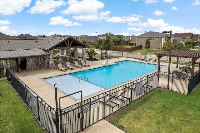 community pool featuring a yard, a patio, fence, and a pergola