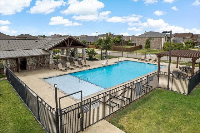 pool with a residential view, a yard, a patio area, and fence