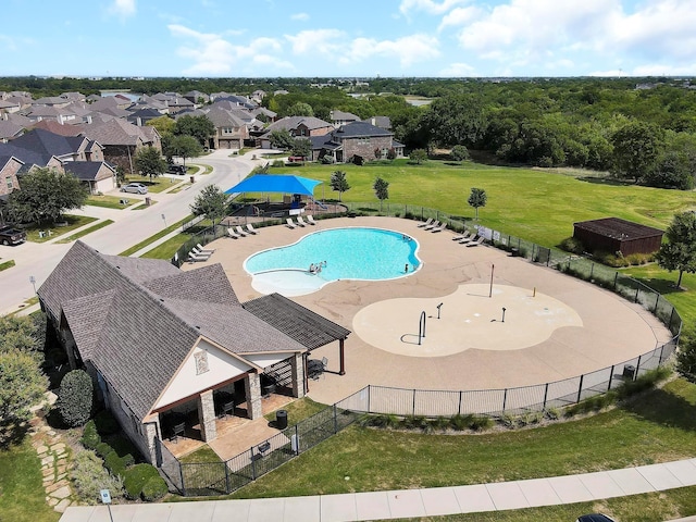 community pool featuring a patio and fence