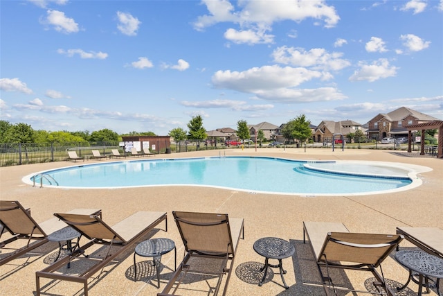 pool featuring a patio area and fence