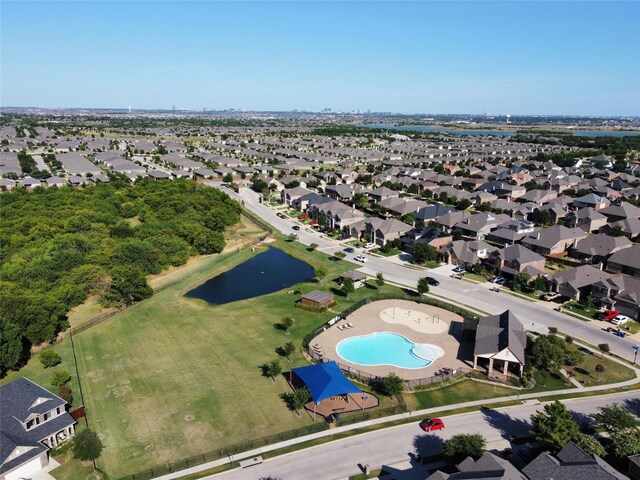 community pool featuring a patio, fence, and a residential view