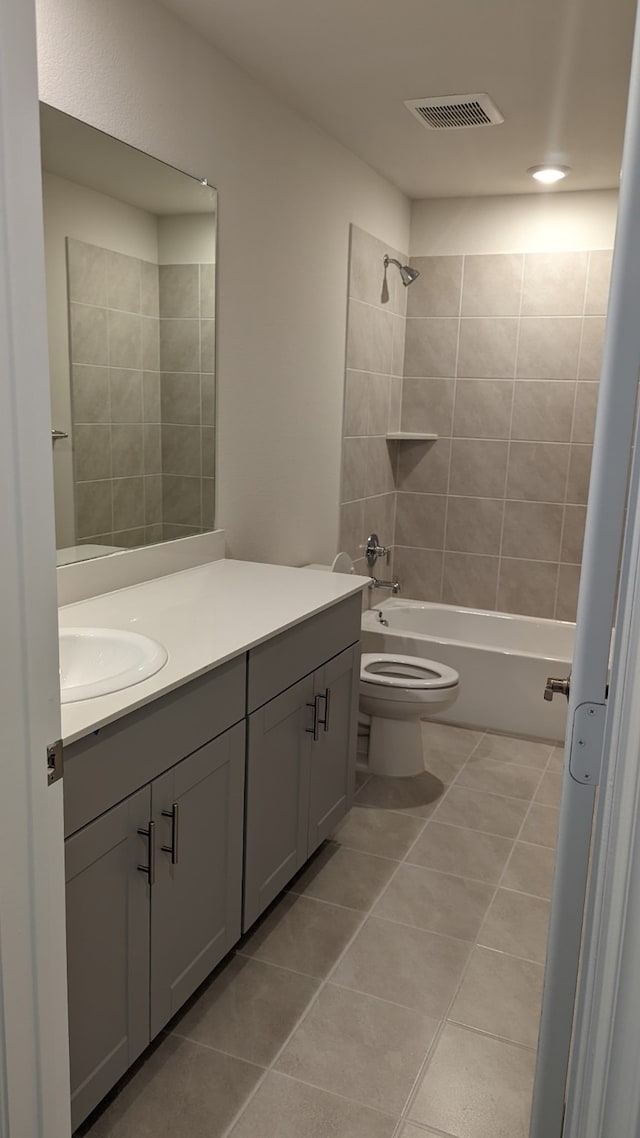 full bath featuring tile patterned flooring, toilet, visible vents, vanity, and  shower combination