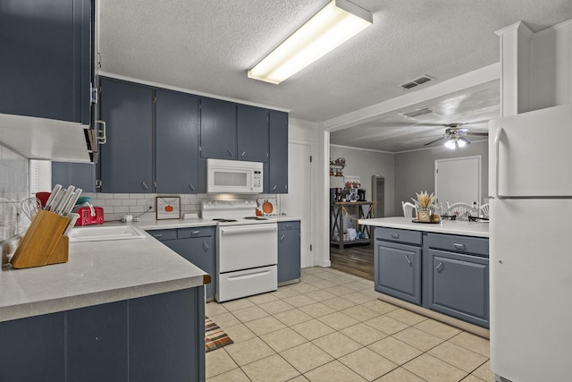 kitchen featuring light countertops, visible vents, ceiling fan, a sink, and white appliances