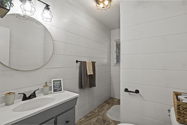 bathroom featuring a textured ceiling and vanity