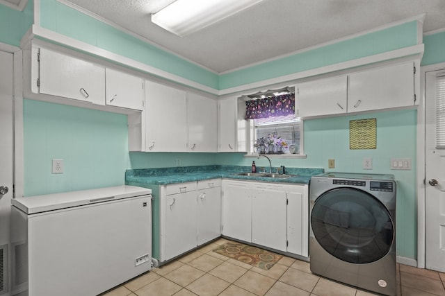 kitchen with light tile patterned floors, washer / clothes dryer, fridge, white cabinetry, and a sink