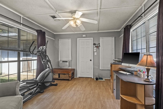 office featuring plenty of natural light, light wood-type flooring, cooling unit, and a ceiling fan