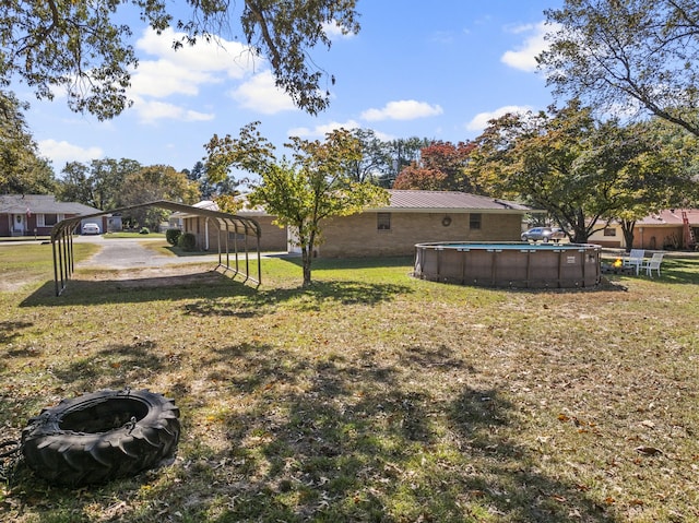 view of yard with an outdoor pool