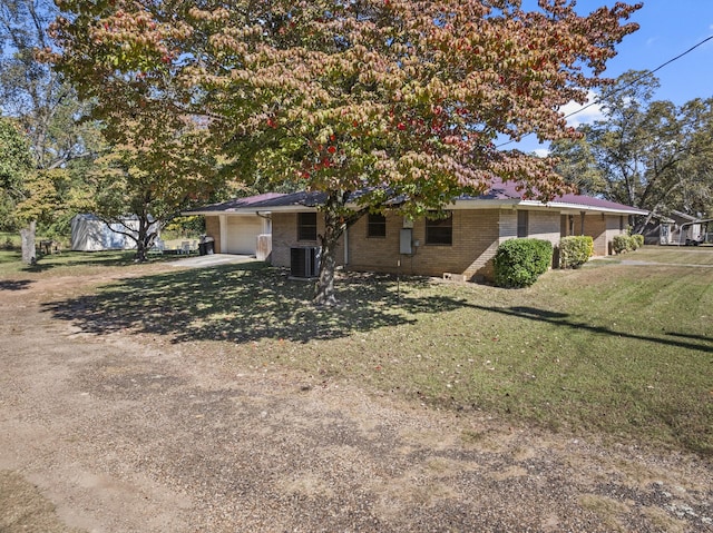 view of front facade featuring a garage, driveway, cooling unit, a front lawn, and brick siding