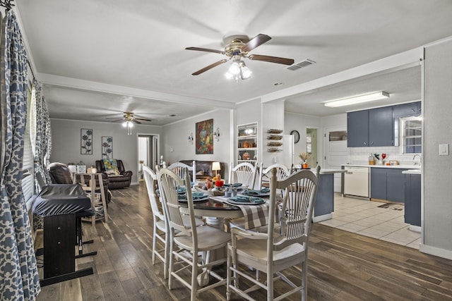 dining area featuring ceiling fan, wood finished floors, and visible vents